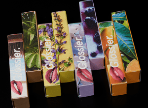 Glossier lipstick boxes with images from nature and vibrant colors.